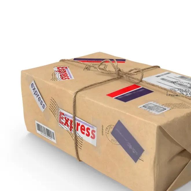 Paczka owinięta papierem i związana sznurkiem, oklejona naklejkami i znaczkami.